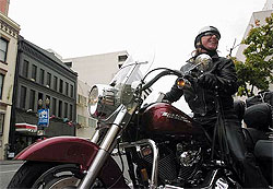 On a Harley Davidson motorcycle, a nurse delivers medications.