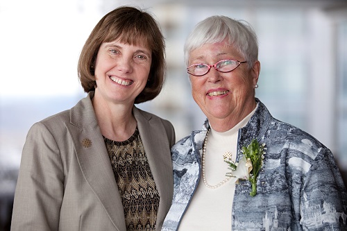 Cornie Stevens and another woman smile at the camera during an OHSU event.