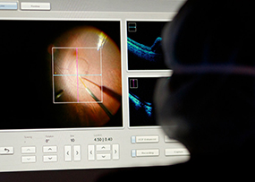 Surgeon watching on the screen while gene therapy is performed. 