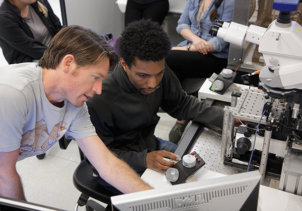Skyler Jackman and Omar Koita working on an e-phys rig