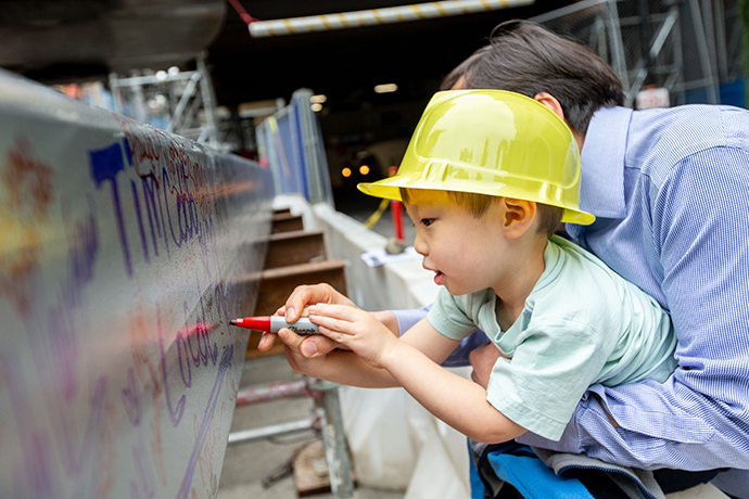 At the beam topping-off ceremony in May 2019, all were welcome to sign the  building's highest beam.