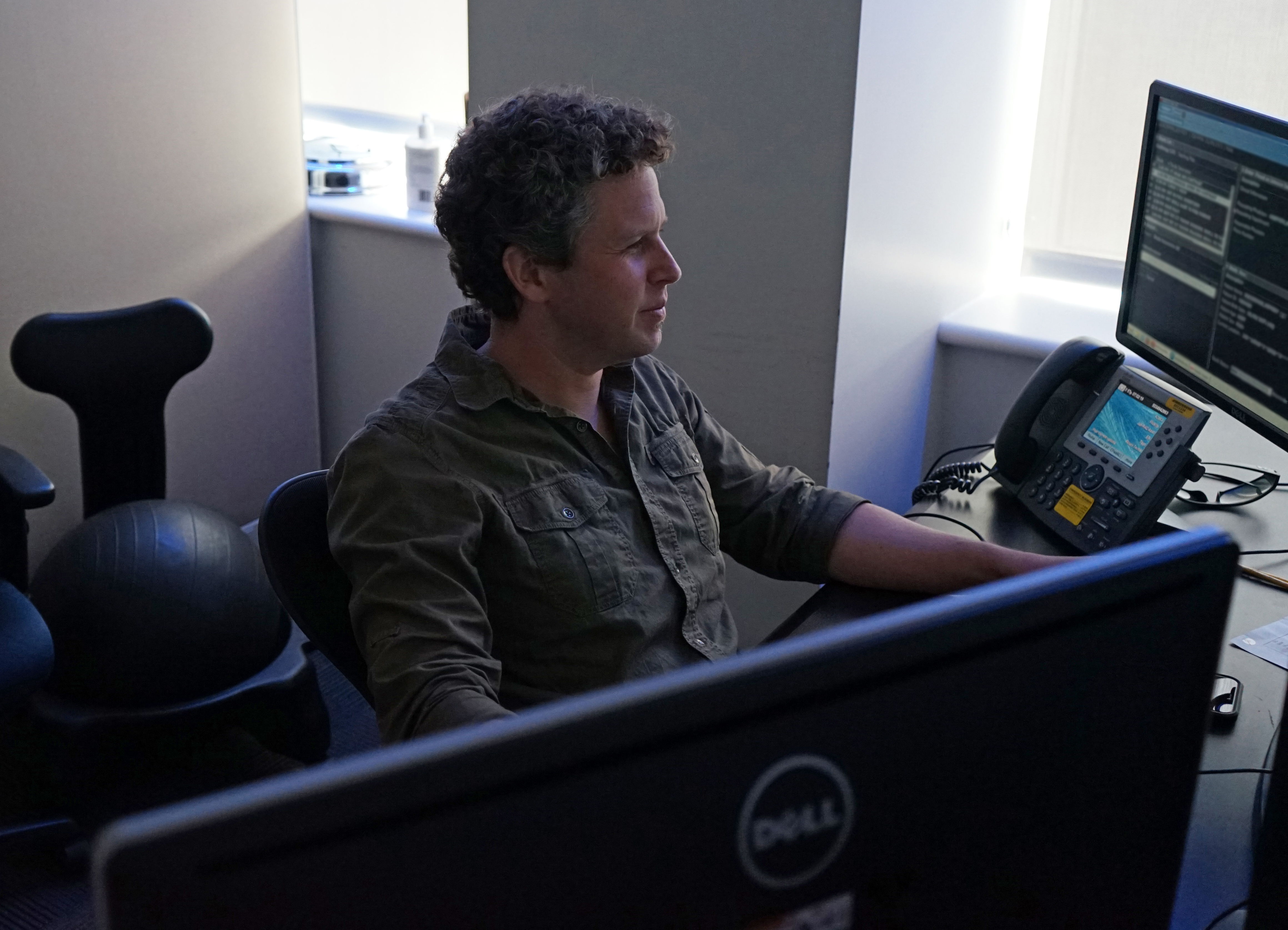 Joshua P. Nickerson, M.D., Neuroradiologist and Radiology Residency Co-Director, at a PACS work station reading studies.