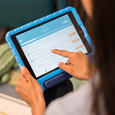 Photo of a person holding a tablet in their hands