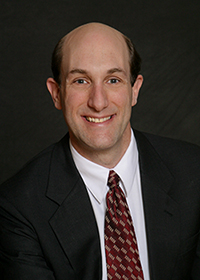 A professional photo of Dr. Joel Solomon.