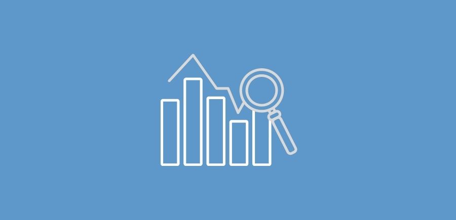 Icon of a bar graph below a line graph and a magnifying glass 