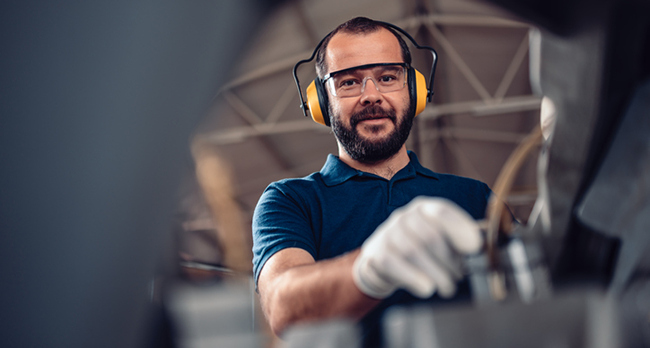 Man working on equipment in a factory.