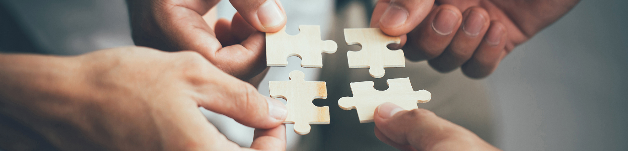 People combine puzzle pieces together