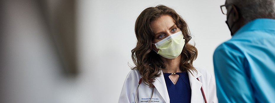 A doctor listens to a patient.