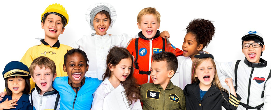 11 children dressed in various professional uniforms smile together.