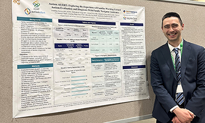Duarte in front of presentation poster