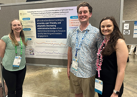 3 presenters in front of  a poster