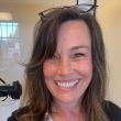 Image of smiling female wearing glasses on her head