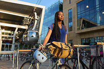 An OHSU student parks her bike in front of the tram.