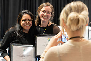 Students smile and pose for a photograph to commemorate their FLAME awards.